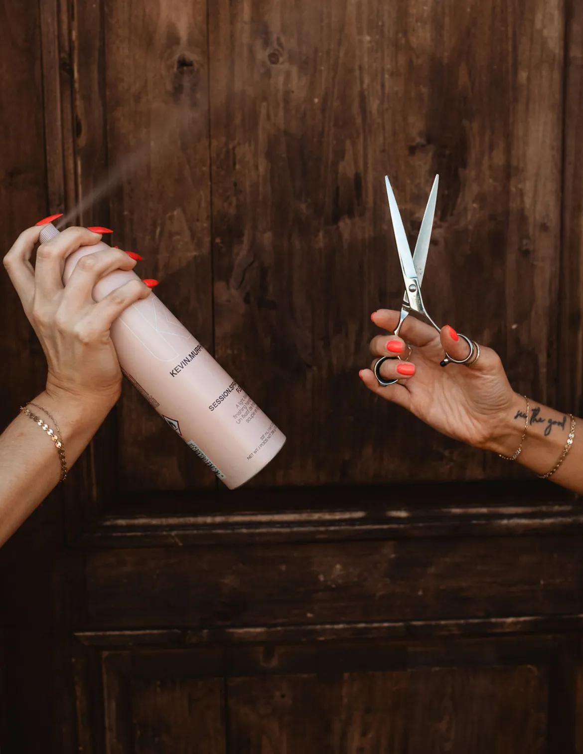 Hairspray mist over professional shears in warm backlight