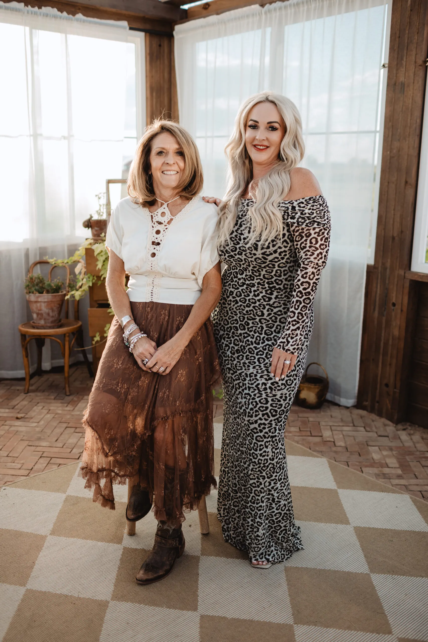 Two Elevate Academy instructors smiling together in the greenhouse studio