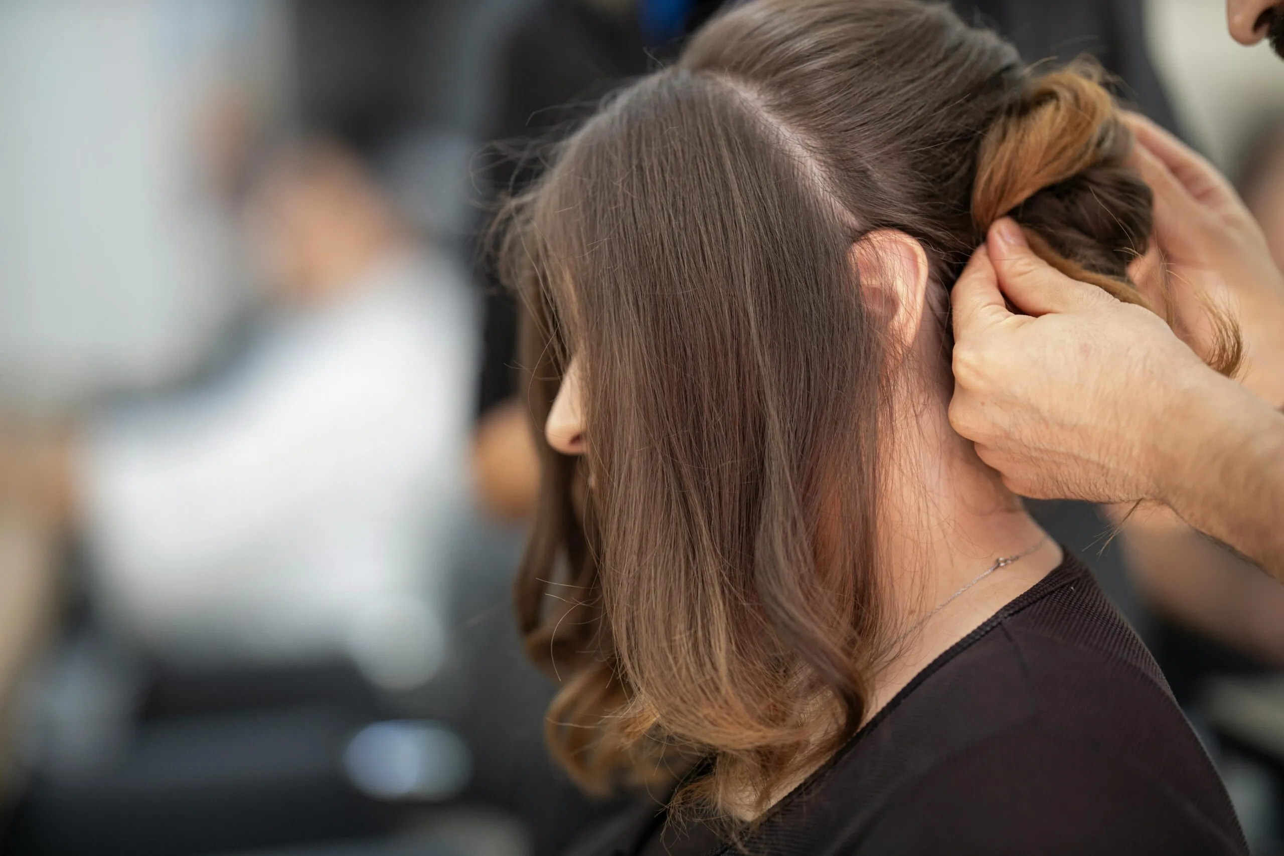 A polished up-do being finished during a styling session